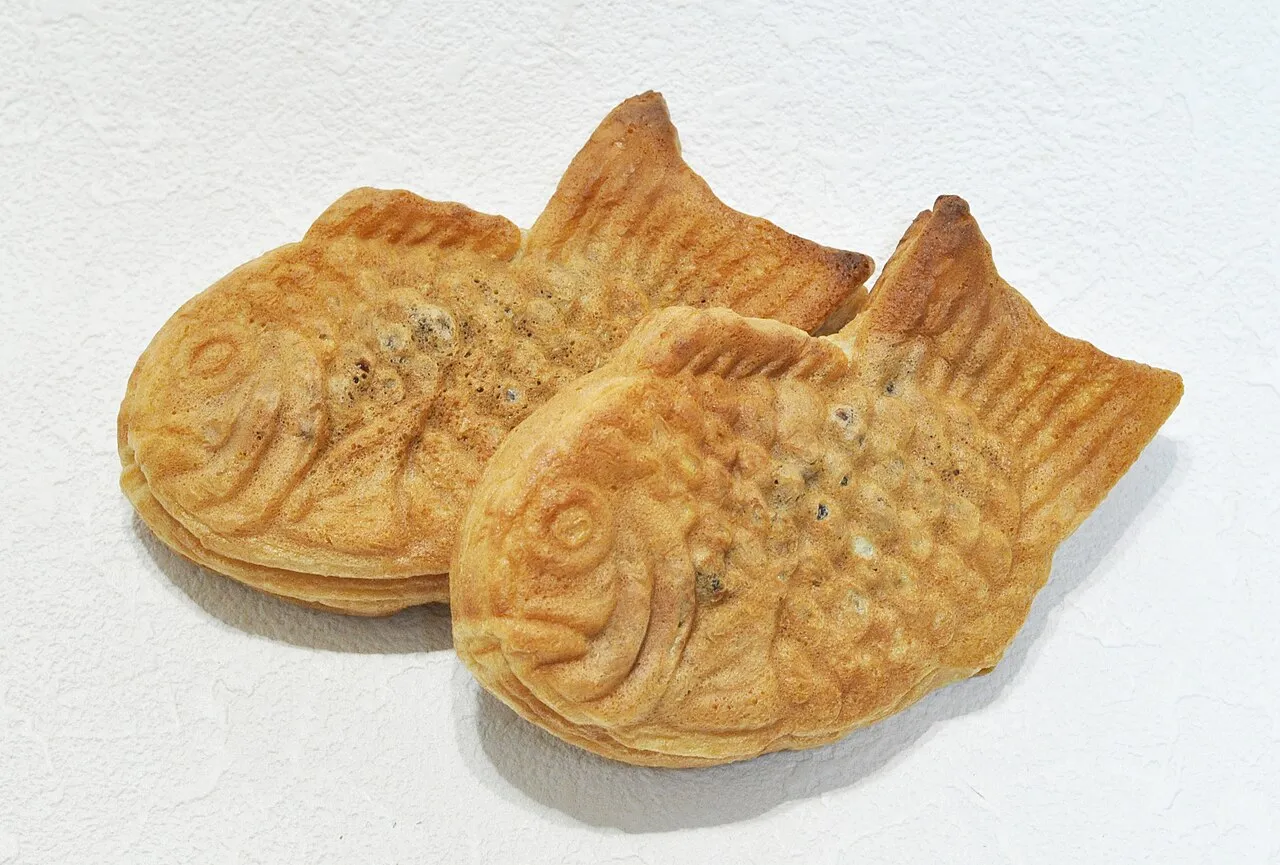 Two golden fish-shaped cakes on a white background.