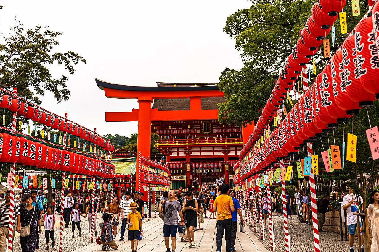 Rows of red paper lanterns line the approach to the great vermilion torii and gate of Fushimi Inari Taisha.