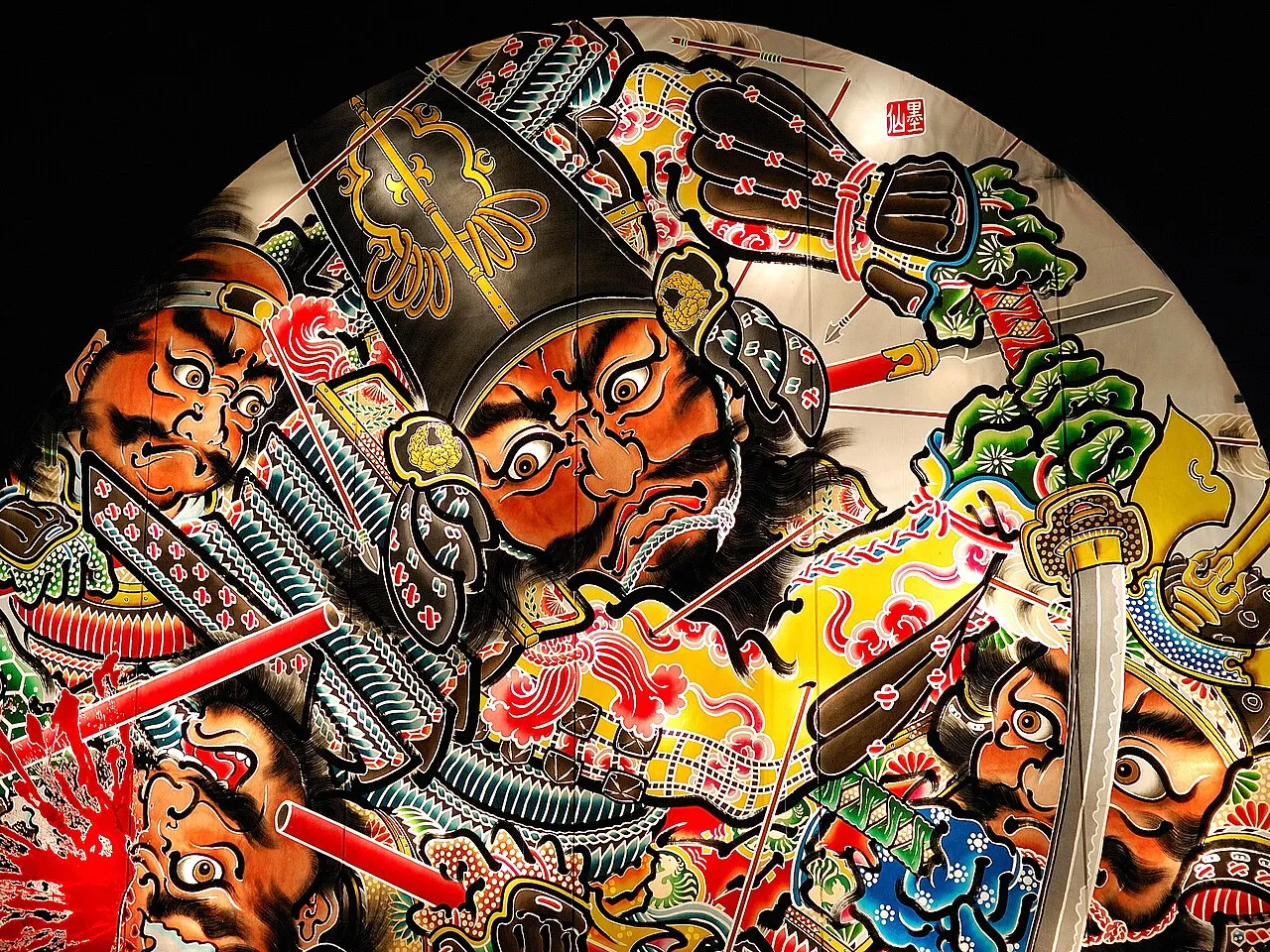 Close-up of a lit paper float painted with warriors in armour, one shot with arrows.